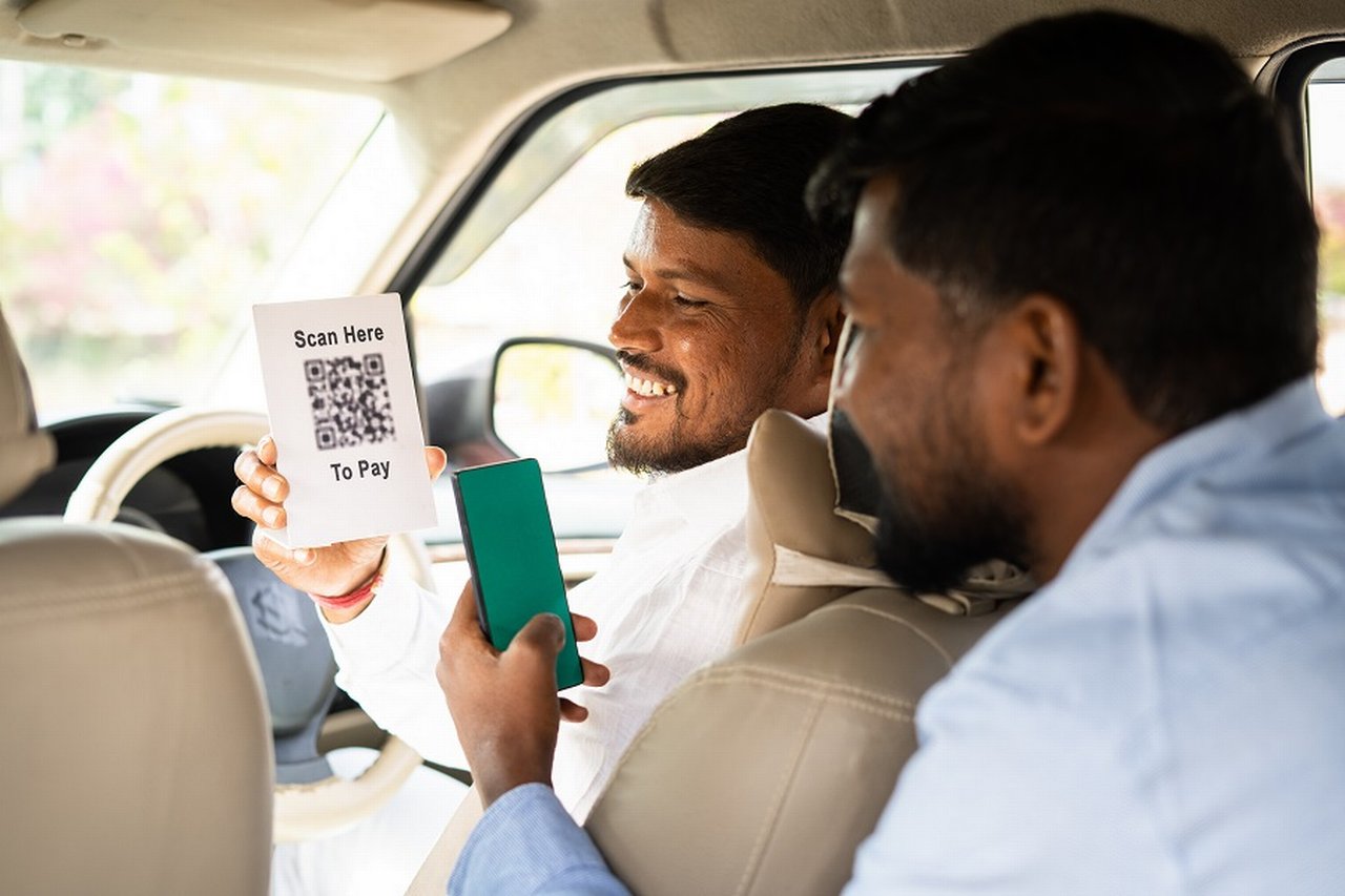 Man scans QR code to pay taxi driver