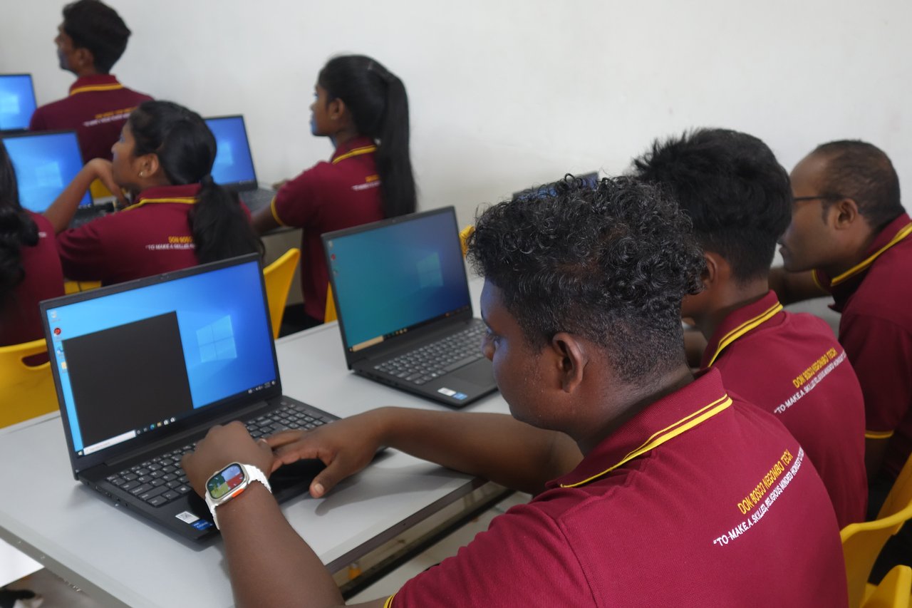 Young people learning basic computer skills