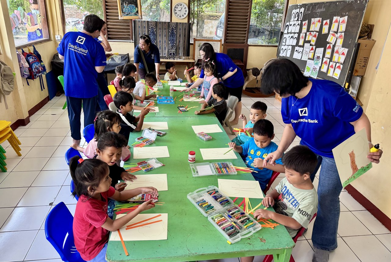 Children taking part in a creative activity with volunteers