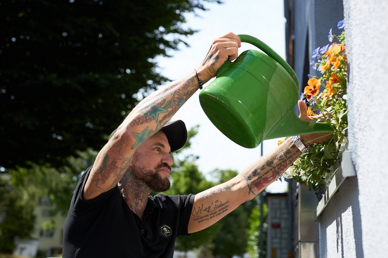 Michael Kapaun watering the flowers