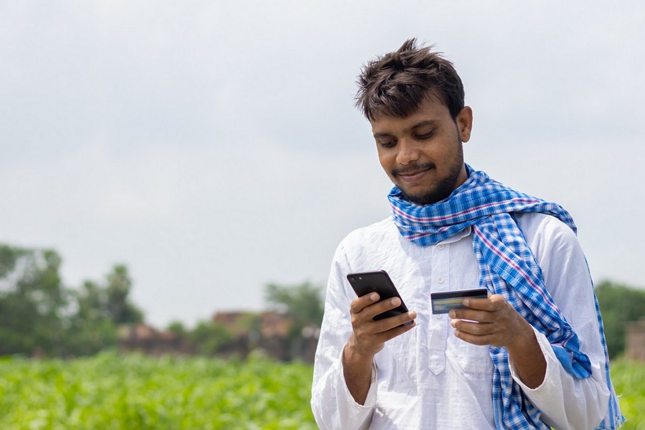 Indian farmer making a payment with his mobile phone