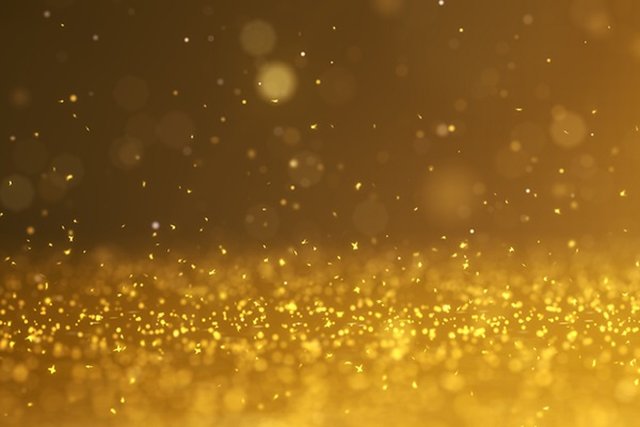 Sparkling gold glitter background with bokeh effect