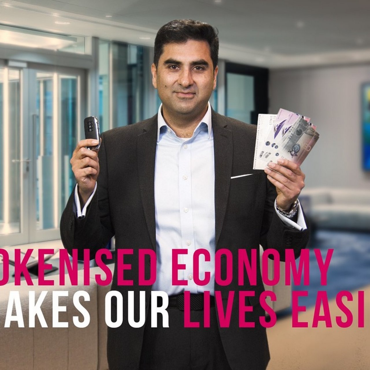 Sabih Behzad holding a car key to demonstrate digital access technology.