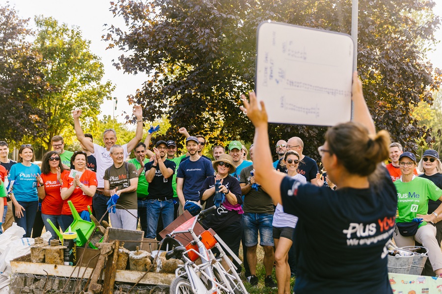Group of volunteers celebrate teamwork after river cleanup