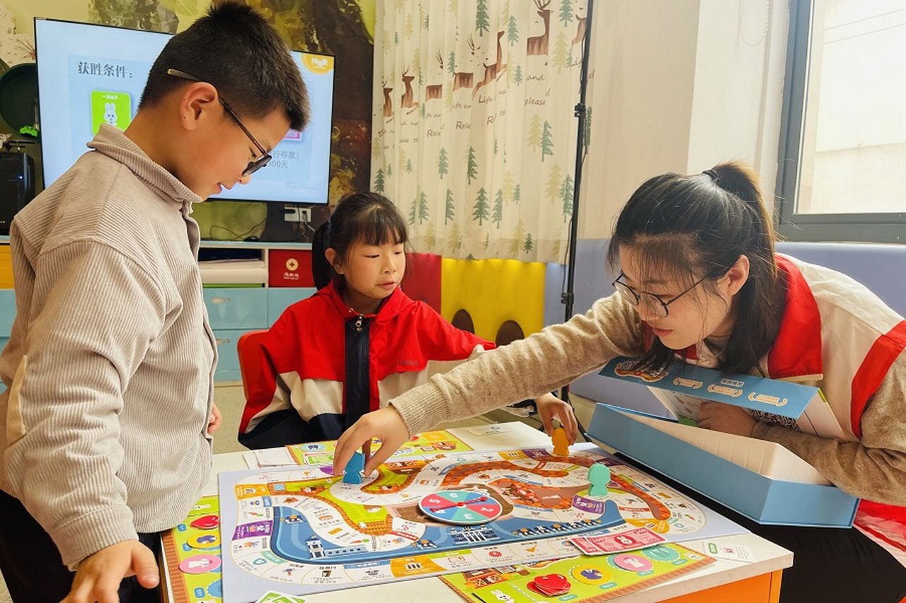 Students play a board game at the Better Education Development Center.
