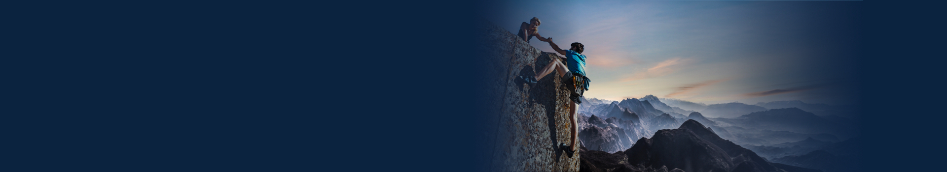 On the photo a woman gives her hand to the man who rises on the mountain top.