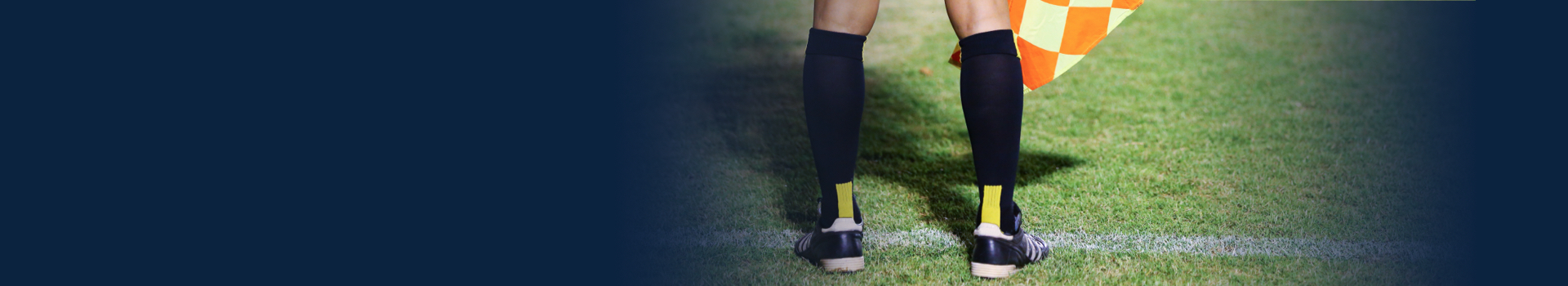 Picture of referee's feet on the soccer field.
