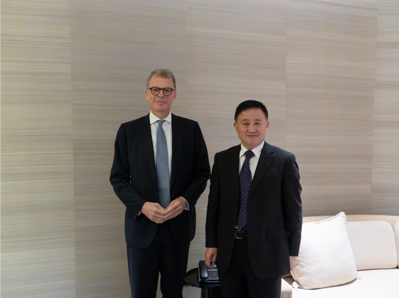 Christian Sewing and Dr. Pan Gongsheng standing in foyer