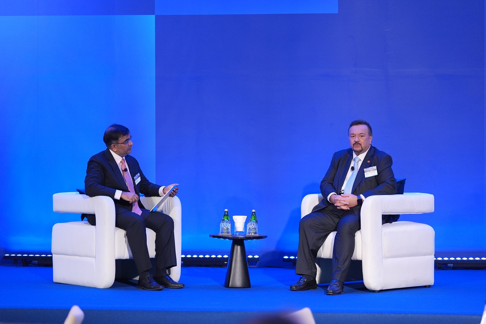 Sameer Goel and Senator Amir Hamzah Azizan sitting opposite each other on stage